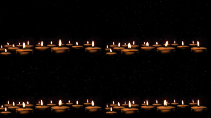 燃烧的蜡烛，模糊的灯光。许多圣诞蜡烛在夜晚燃烧。抽象蜡烛背景