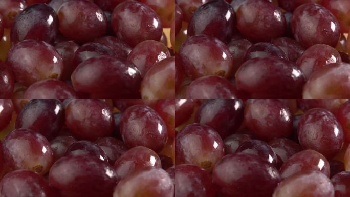 新鲜的一串串红色或粉红色的葡萄作为背景旋转。葡萄特写，概念酿酒，葡萄酒生产，葡萄品种