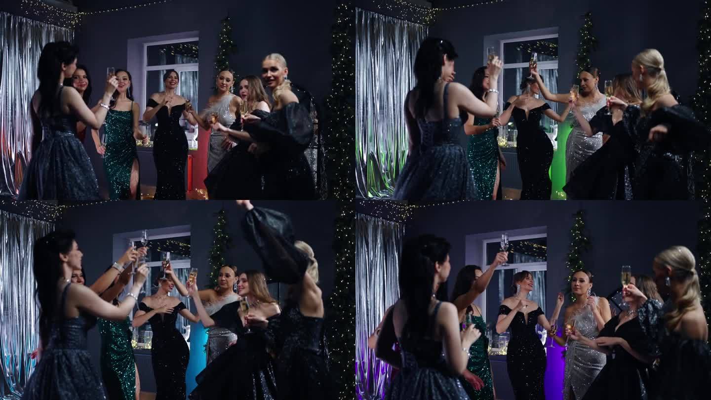 性感的女性朋友在快乐的圣诞晚会上跳舞，魅力的年轻女士庆祝新年