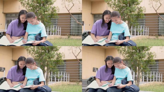 快乐的亚洲女生在学校里学习和讨论家庭作业
