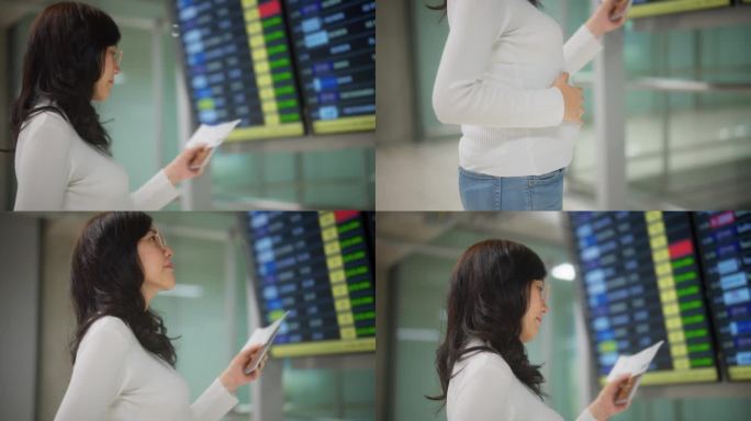 怀孕的亚洲女商务旅客在机场候机楼查看航班时刻表。