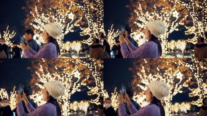 一名亚洲女子在圣诞之夜用她的手机拍下了这座城市的照片。