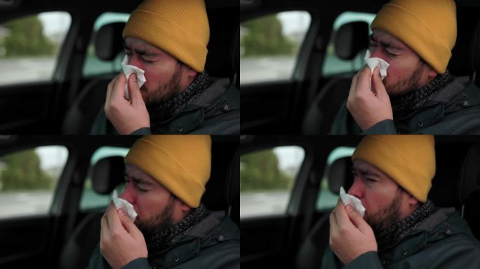 在疾病中驾车大胡子司机在季节性疾病中咳嗽