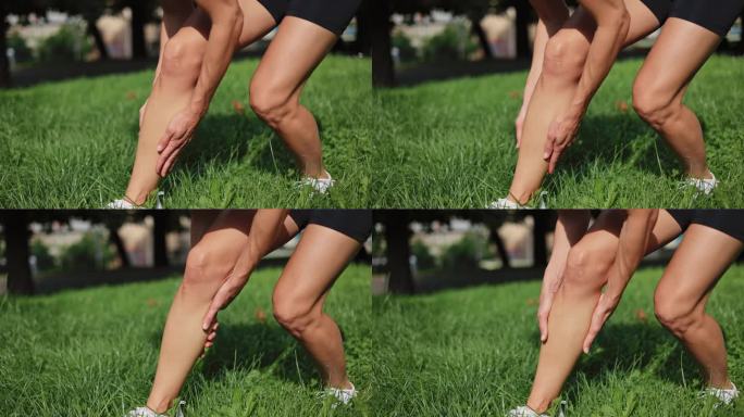 身材苗条的白人妇女在新鲜空气中剧烈运动后腿部肌肉痉挛。身着黑色短裤和白色运动鞋的健身女士站在草地上按
