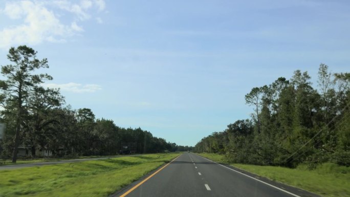 飓风区的高速公路，在北佛罗里达小镇周围被毁坏的广告牌中行驶。路上被毁坏的广告牌。道路POV