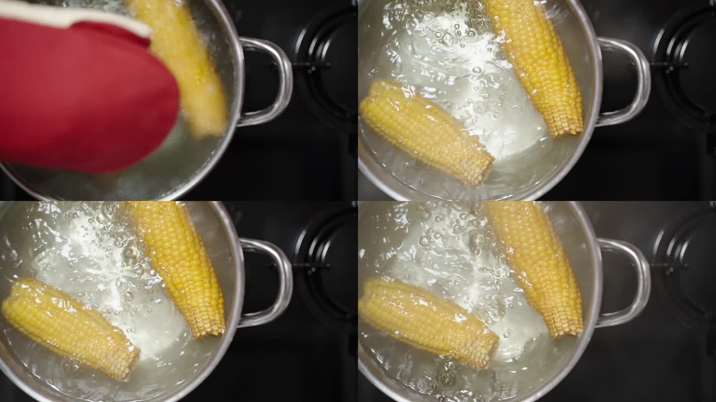 玉米在沸水中沸腾，从上往下看，盖子被戴着手套的手慢慢打开。缓慢的运动。