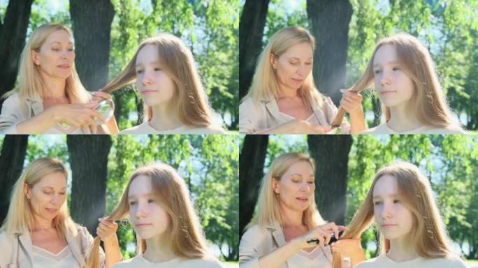 在春天的公园里，尽职的母亲熟练地为十几岁的女儿编织头发