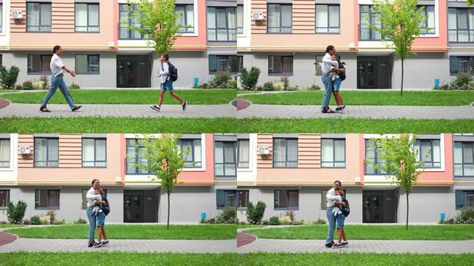快乐的非裔美国母亲在放学后可爱地问候她的儿子。放学后，站在学校大楼外的母亲与孩子拥抱。家庭的概念。