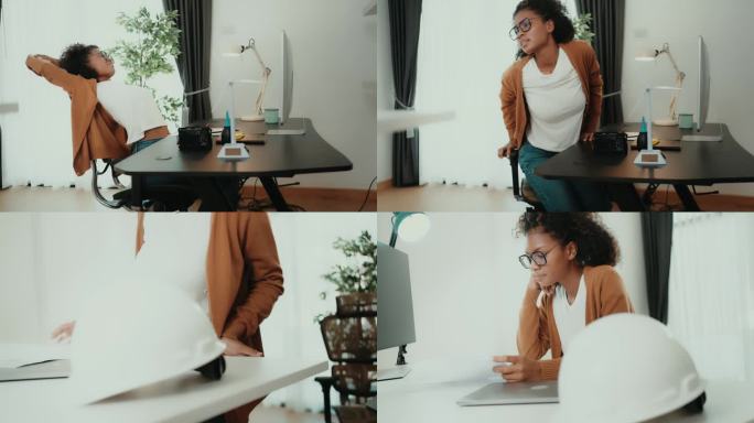 黑人女企业主坐在现代办公室里用电脑工作。