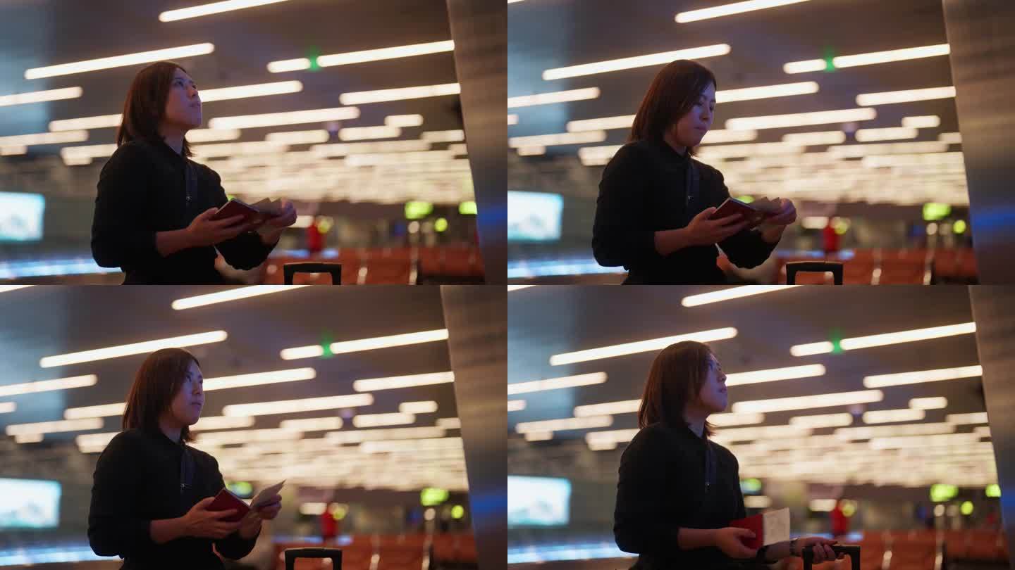 亚洲女游客在机场查询航班信息