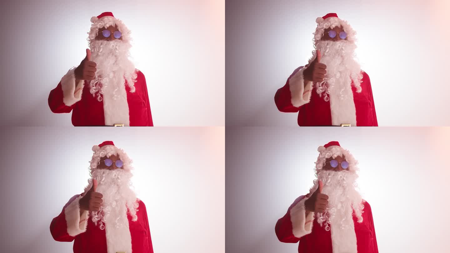 快乐的圣诞老人画像。微笑的非洲裔美国人穿着圣诞老人的圣诞服装，特写镜头，看着镜头，在白色的背景上摆姿