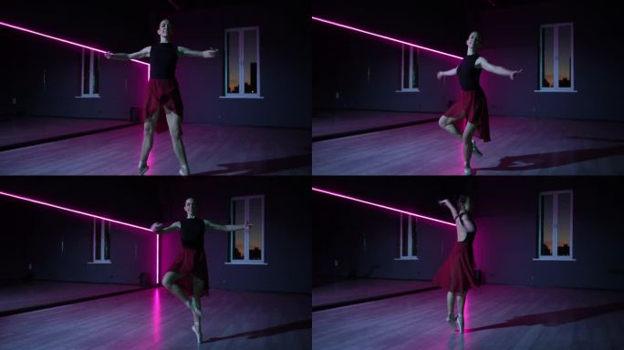 住相机。一个美丽的芭蕾舞演员在霓虹灯照亮的黑暗舞蹈大厅里优雅的动作。