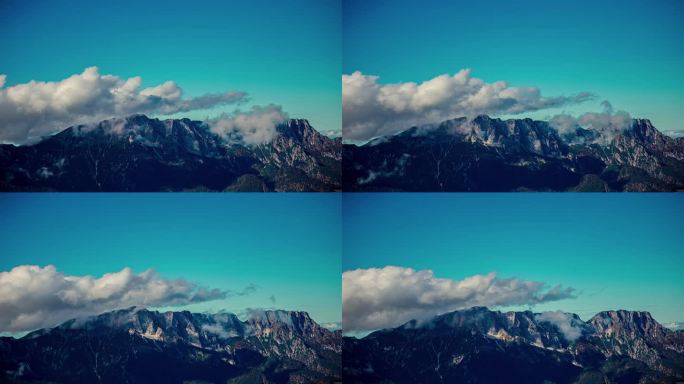 白云在蓝天的映衬下掠过山峰。延时拍摄。