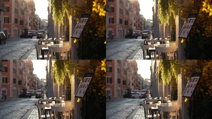 日出时没有客人的意大利餐厅餐桌，背景是柔和的阳光。街上空荡荡的咖啡馆。复古街的户外咖啡馆。