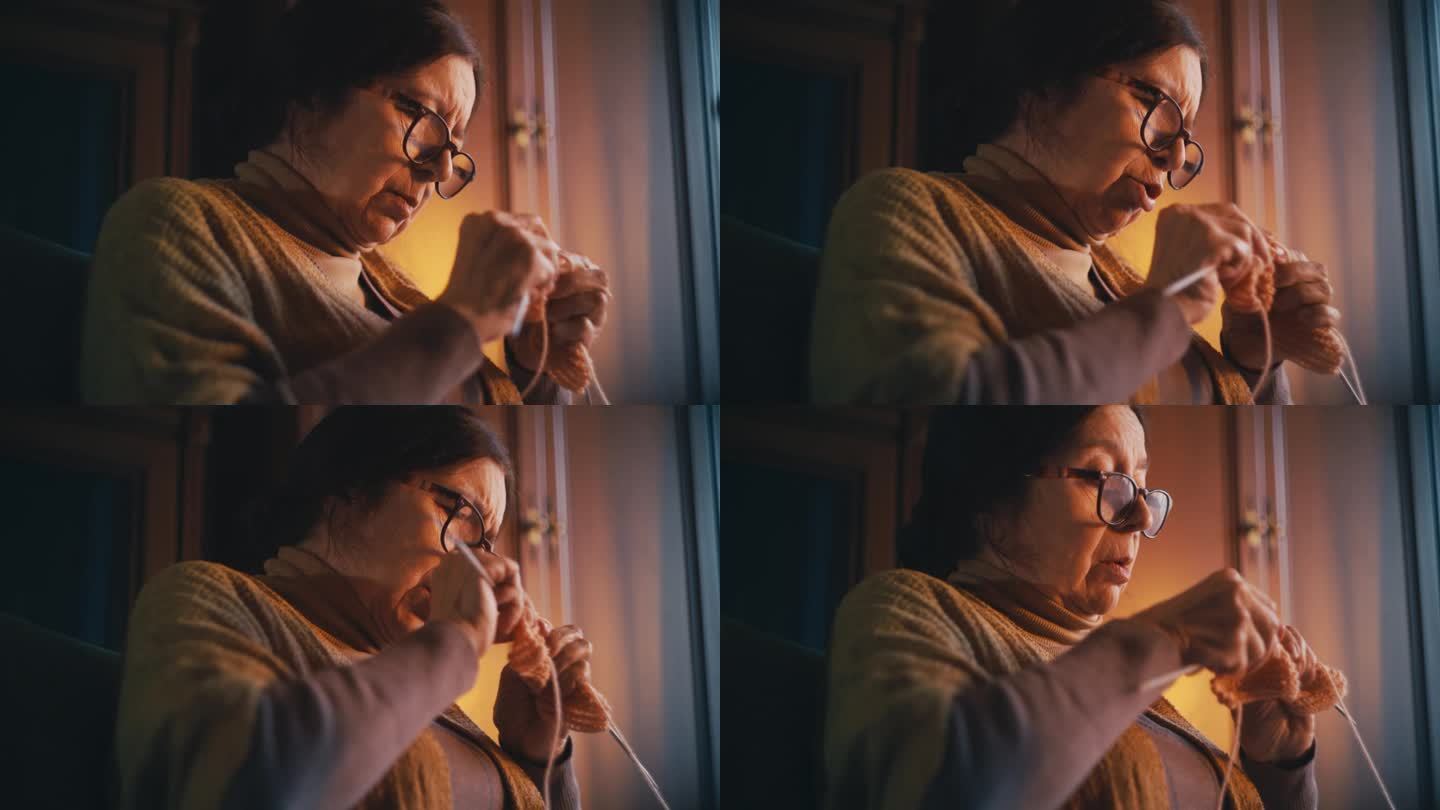 集中奶奶戴着眼镜在家织围巾，老年爱好