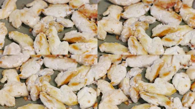鸡胸肉在油锅上煎炸，近距离慢动作全画幅背景，选择性对焦和浅景深