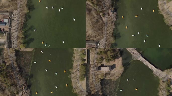 航拍无人机带着相机在中国寺庙中心的湖中拍摄船只