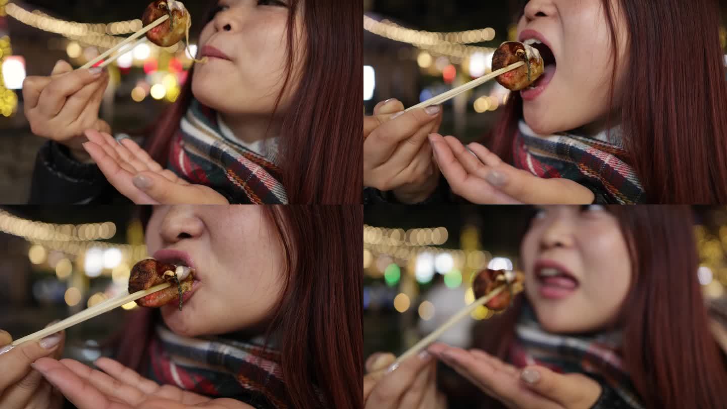 年轻女子在圣诞夜吃着街头小吃章鱼烧