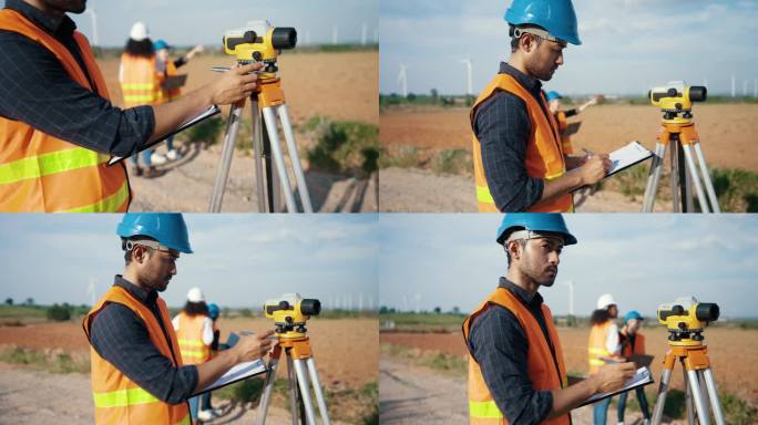 一位亚洲男性测量工程师使用建筑商的水平仪来规划风力发电场的扩展。