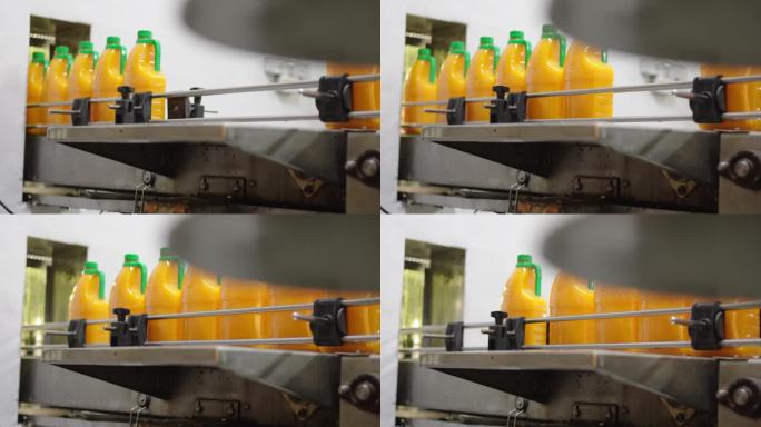 瓶装果汁饮料生产线在工厂的传送带上移动