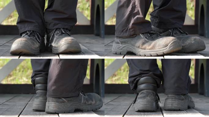 男人站在木板上，转过身来，可以看到旧鞋的后面。贫穷的概念。