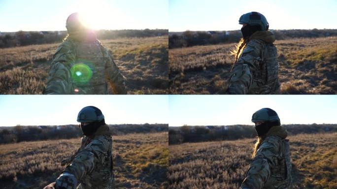 跟随我拍摄的年轻女兵在日落时分牵着男性的手慢跑穿过田野。欢快的女兵拉着她的男朋友在草地上走。快乐的军
