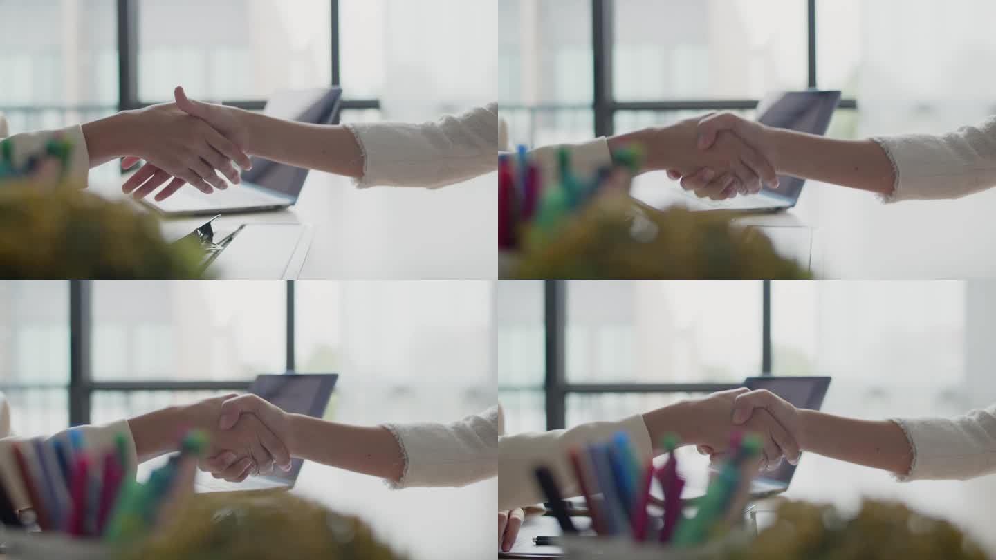 老板在办公室面试后与新员工握手的特写镜头。