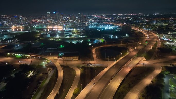 上图是佛罗里达州坦帕市宽阔的高速公路十字路口，夜间车辆疾速行驶。美国交通基础设施概念