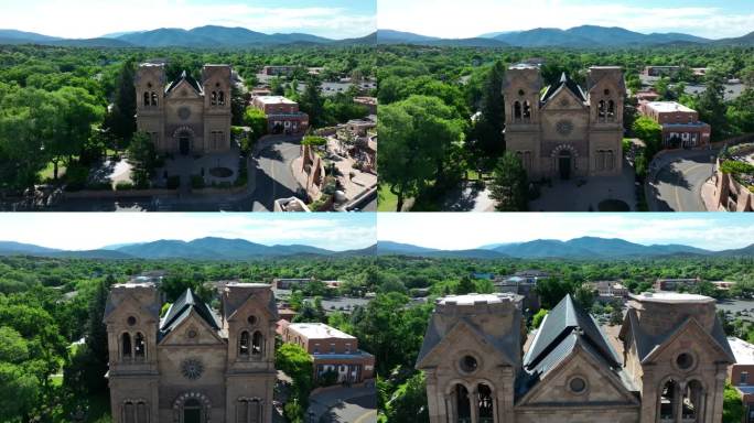 新墨西哥州圣达菲的圣方济各大教堂。历史悠久的石头教堂，在郁郁葱葱的山景中有两座钟楼。天线。