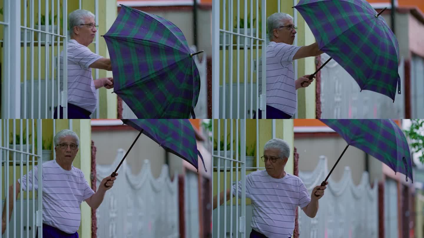 一个成熟的男人在恶劣的天气里撑开雨伞。上了年纪的白种人走在街上，在雨中离开家
