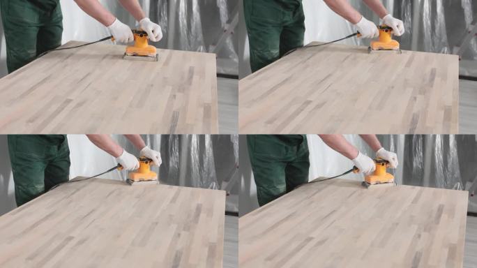 男木匠用轨道磨砂机打磨镶木地板