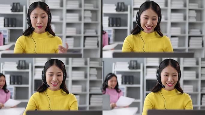 年轻的亚洲女性电话接线员，在办公室用电脑与客户交谈。