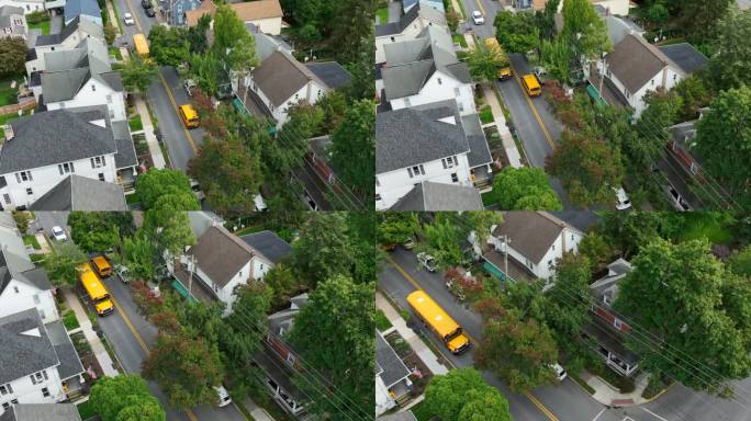 黄色校车行驶在美国城镇街道上。秋日航拍跟踪拍摄。