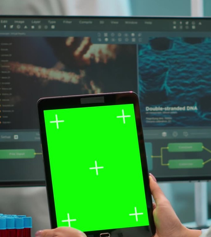 垂直视频:科学家手持绿色色度键屏的平板电脑