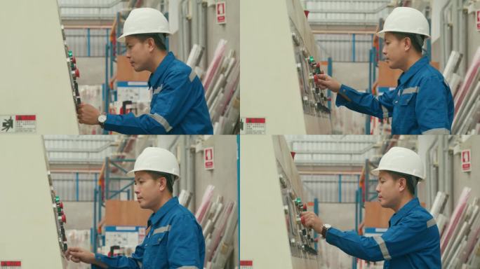 专业的亚洲男性工业工程师在制造工厂操作机器键盘。在制造厂或生产厂工作。