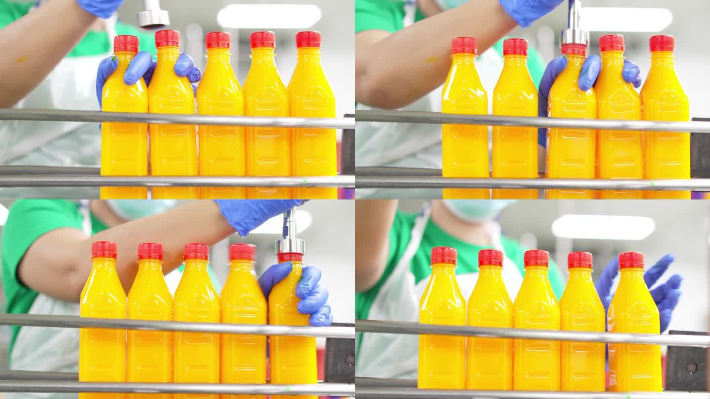 亚洲华人果汁厂工人在生产线上给橙汁封盖