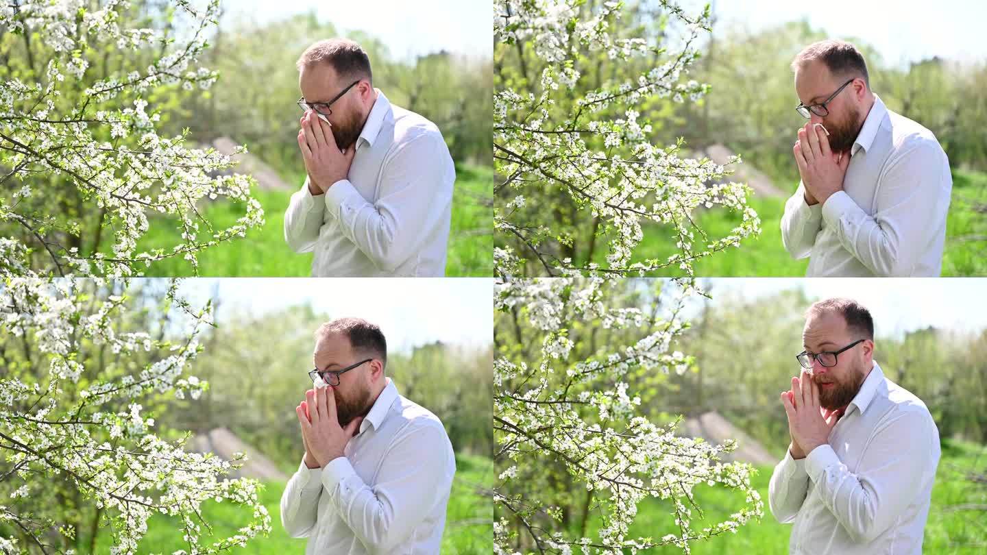 男士春季季节性过敏，打喷嚏，用手绢擤鼻涕。