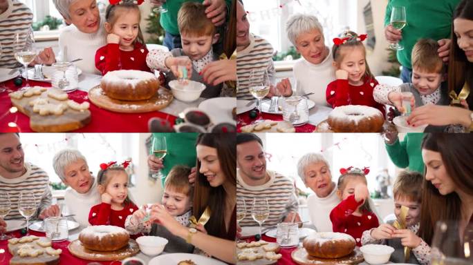 在家庭圣诞午餐期间，孩子们用蛋糕洒装饰蛋糕