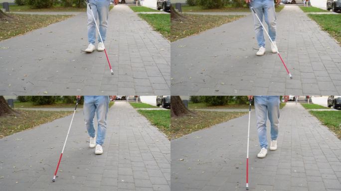 一个盲人拄着拐杖的特写