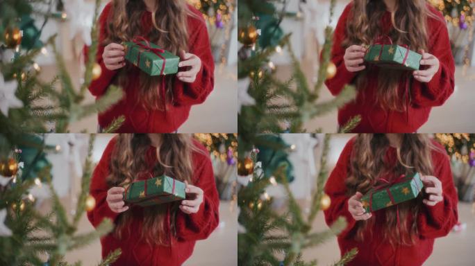 穿红毛衣的女人在家里拿着圣诞礼物