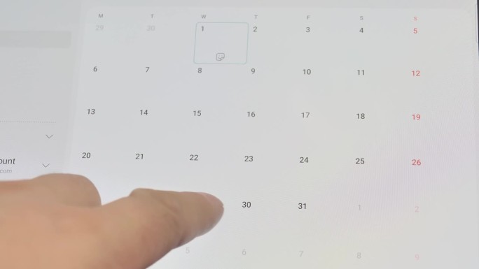 智能手机的特写，手指滚动日历寻找正确的日期。确认会议或约会