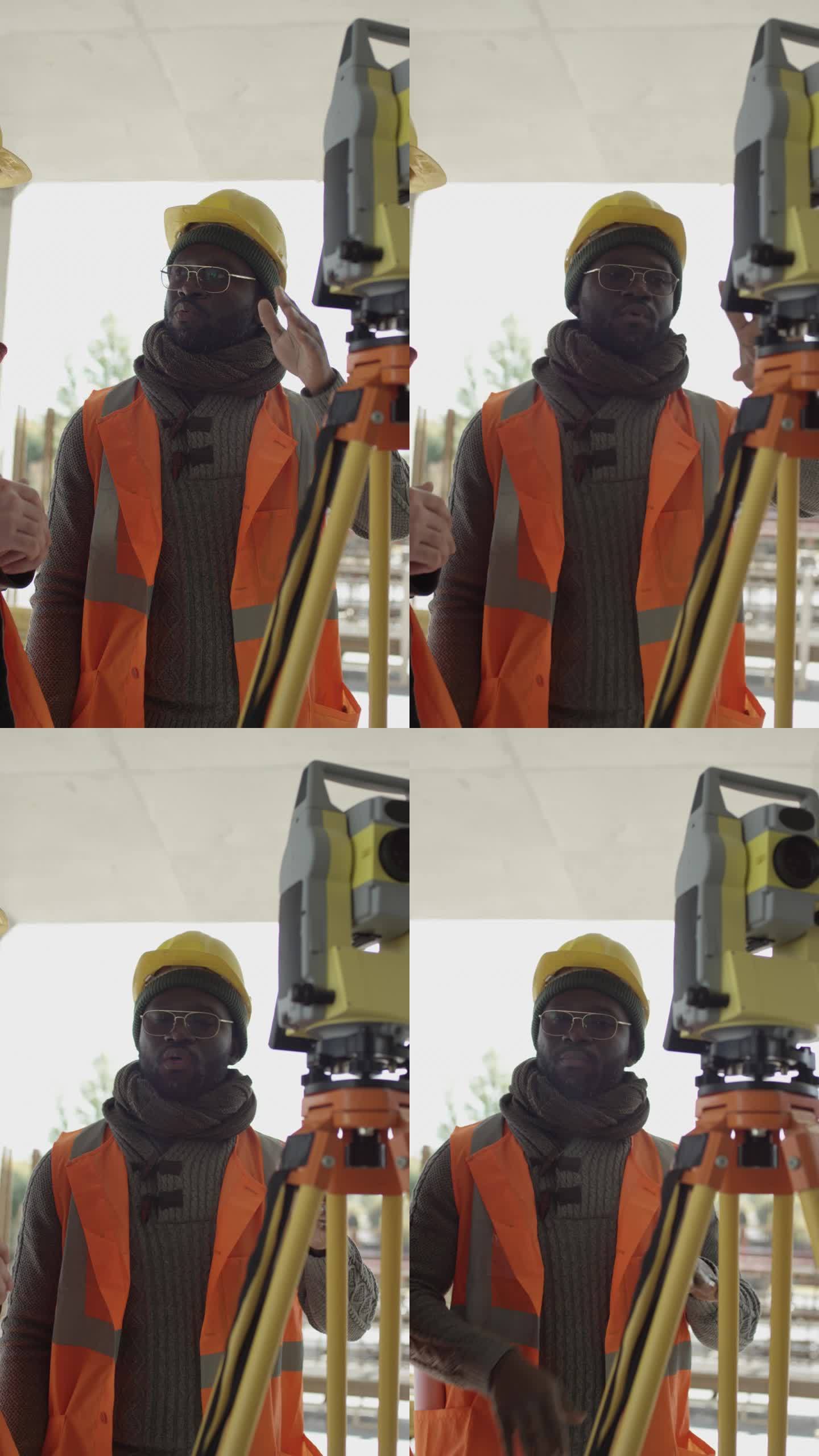 非裔美国工程师在建筑工地使用全站仪