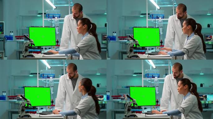 科学家们在电脑前用绿色色度键屏讨论