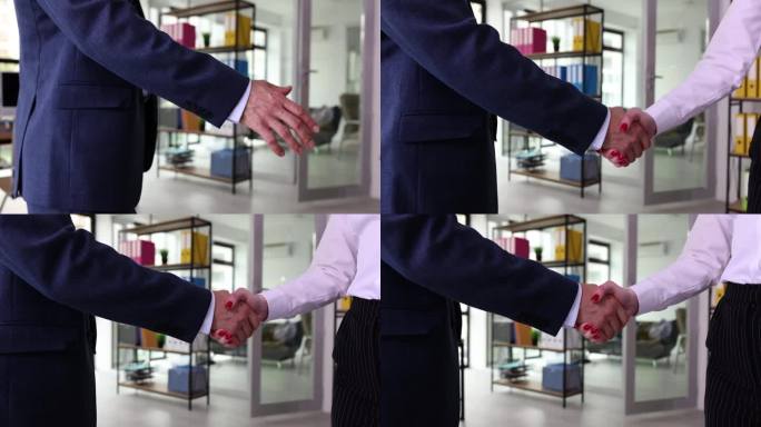 商人和女人在办公室里握手特写
