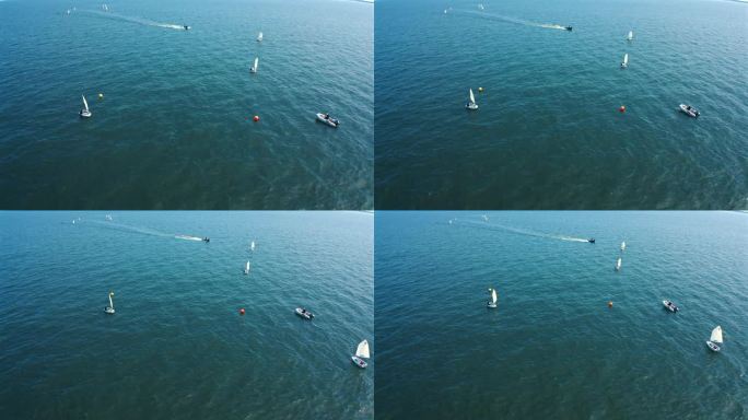 无人机拍摄的乐观主义小艇航行在海上在阳光明媚的一天