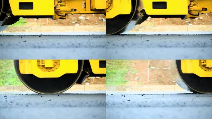 工人使用压路机压实沥青，串联式压路机是一种重型压实施工车辆，用于平整道路施工中的土壤，砾石，混凝土或