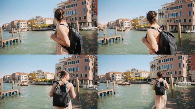 度假期间，威尼斯蓝天下的运河旁，背着背包微笑的年轻女游客