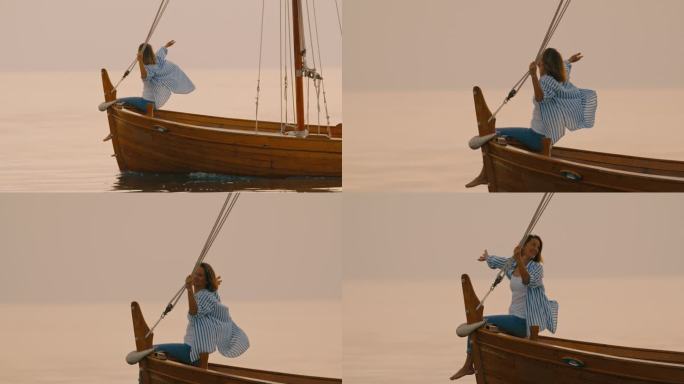 SLO MO航行宁静:黄昏时分，一名女子在船头航行，享受着海风