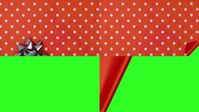 打开礼物与银色蝴蝶结在红色背景与波尔卡点。揭示绿屏定格动画。色度键。