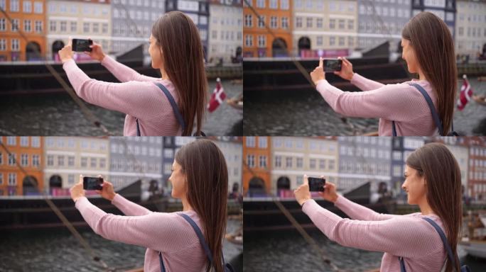 一名白人妇女用手机拍摄哥本哈根的新港运河